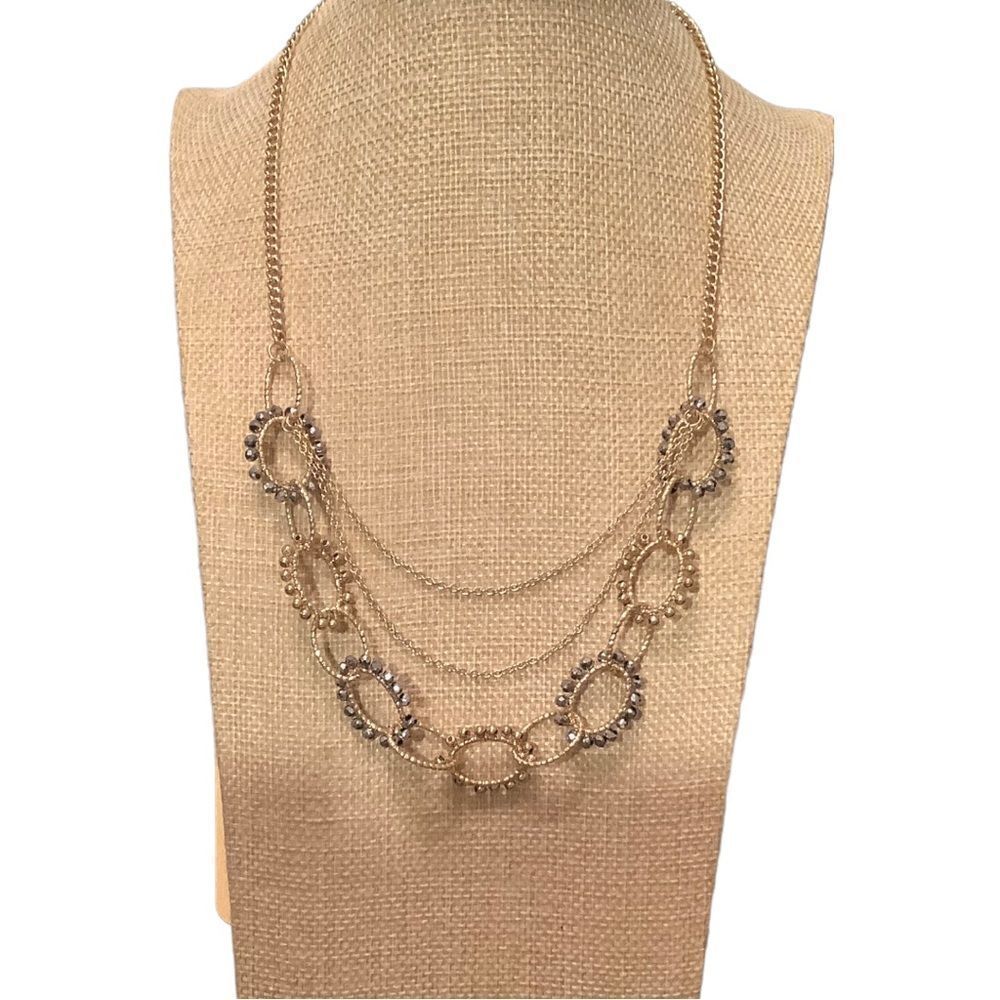 Gold tone multi layer necklace with earrings. NWOT
